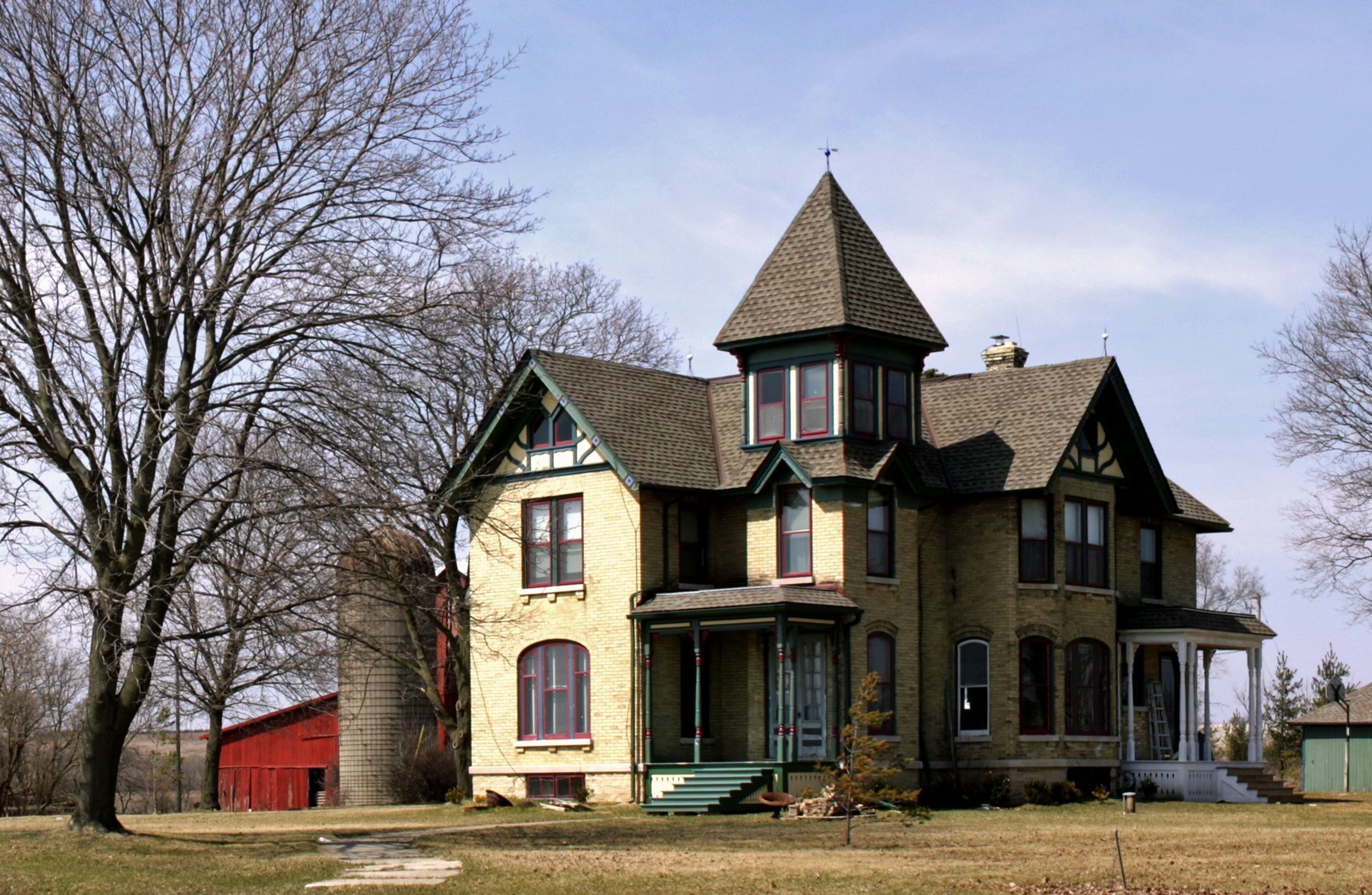 A beautiful shot of a big farmhouse in a clear blue sky